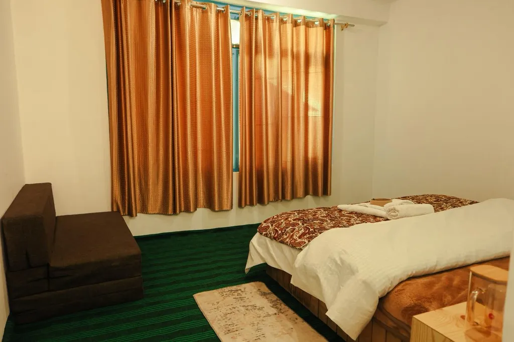 Comfortable Bedroom With Golden Curtains Homestay